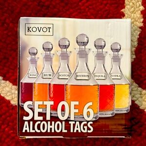 A 6 piece set of silver coated metal, liquor tags with matching chains. New!